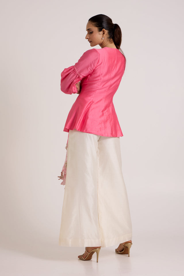 Jay pink Velan top and ivory pants, back view showing the fitted back and puff sleeves