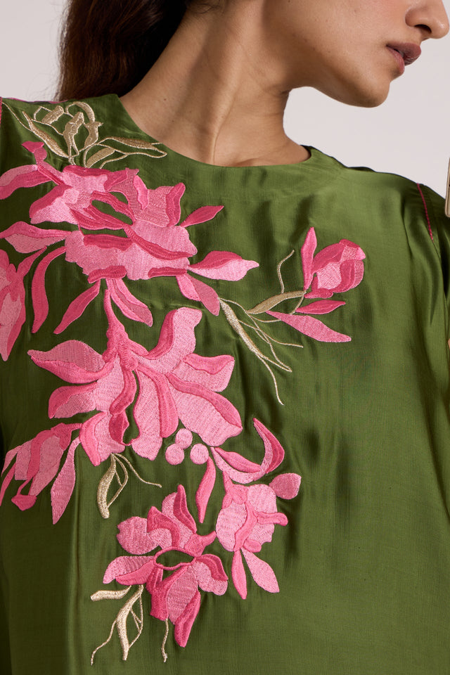 Close-up of the Zuma olive top round neckline and pink floral embroidery