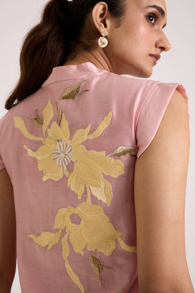Close back view of the Helga ice pink dress with large yellow floral applique