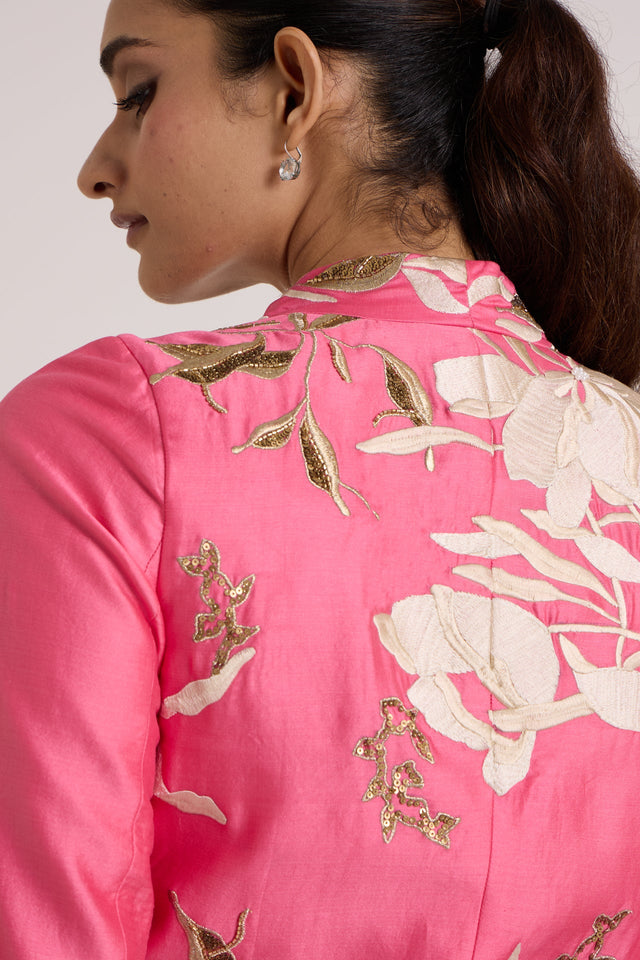 Close back view of the Eddie pink top shoulder with ivory floral applique and gold sequins