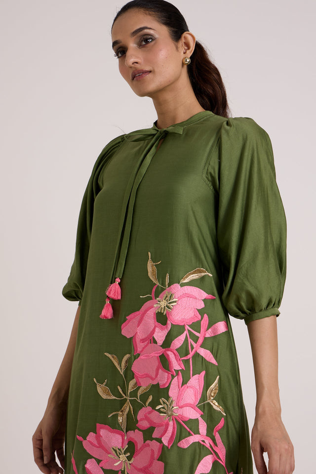 Close view of the Vinny olive dress puff sleeve, tassel tie and pink floral applique