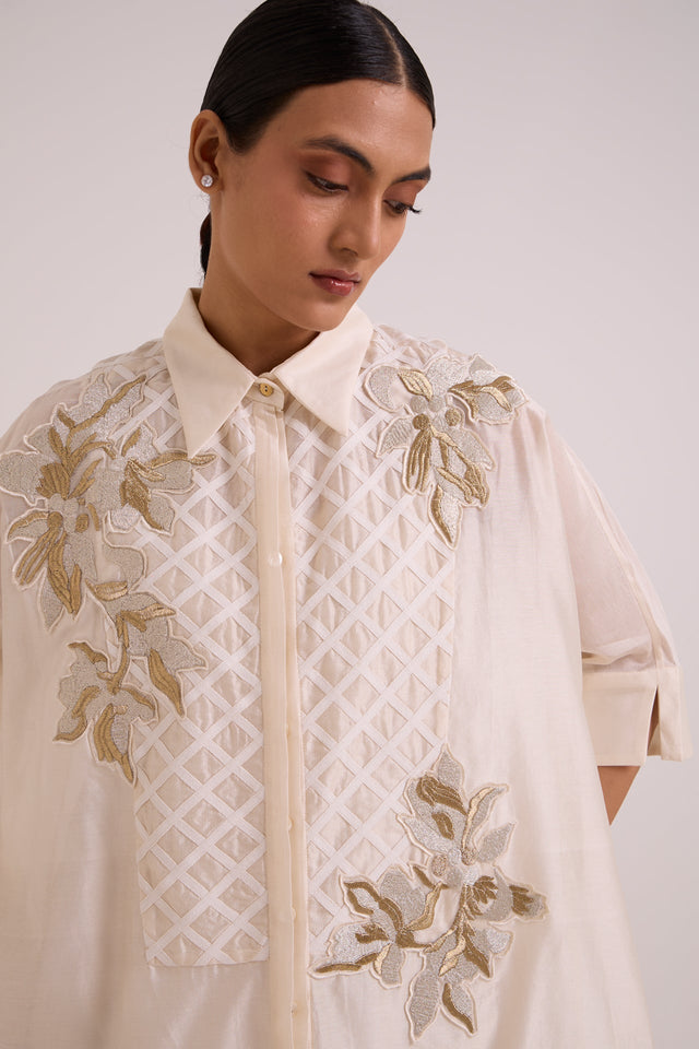 Close-up of the Mimi shirt dress collar, button placket and gold floral applique on the lattice