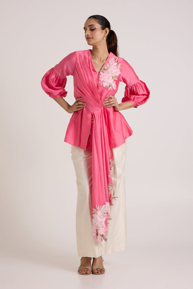 Jay pink Velan drop top with puff sleeves and hands on the waist, full length front view