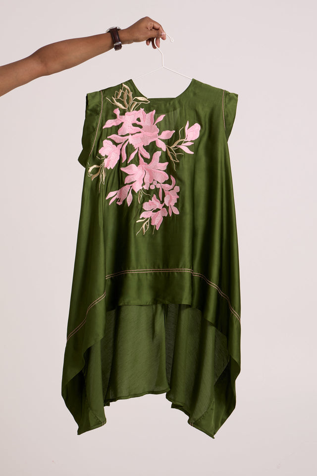 Olive Ice Zuma Fly High Trail Top by Madder Much, olive asymmetric sleeveless top with pink floral applique on a hanger