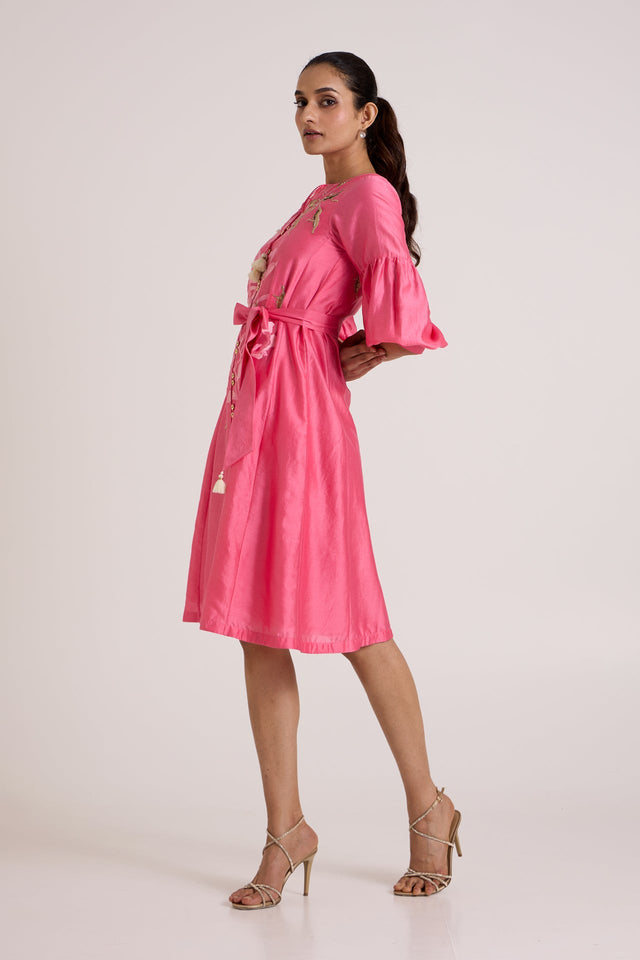 Jay pink Delphi floral midi dress with hands behind the back, side view