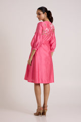 Jay pink Delphi midi dress looking over the shoulder, back view with floral embroidery
