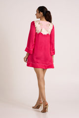 Jay pink Cory short dress looking over the shoulder, back view with floral applique yoke