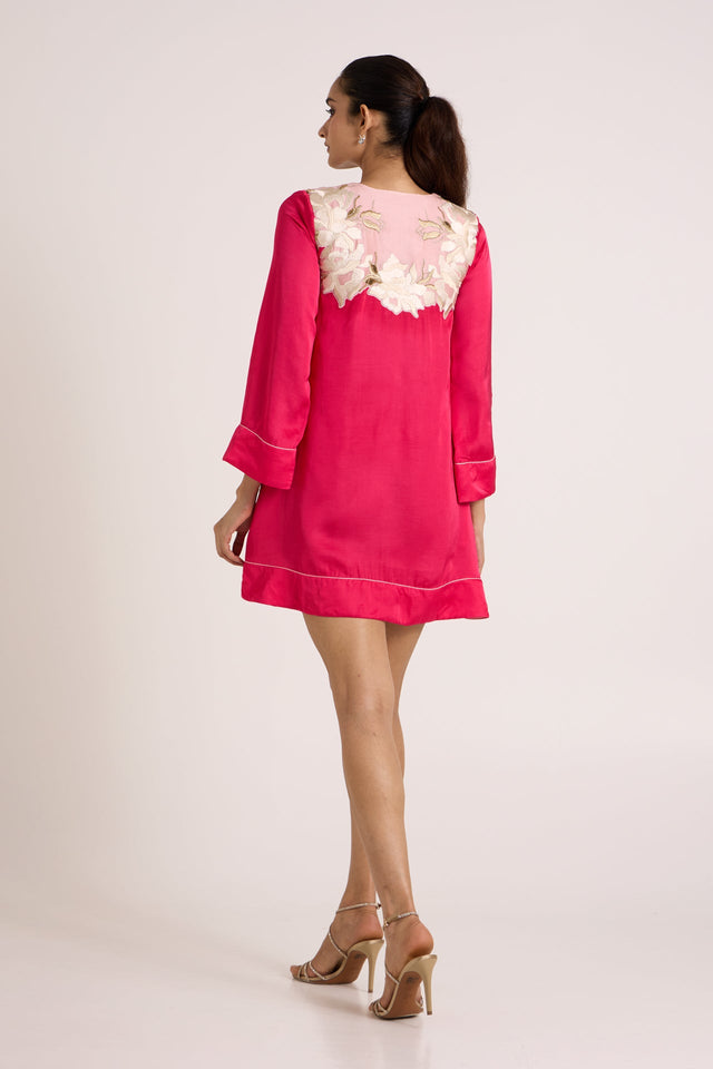 Jay pink Cory short dress looking over the shoulder, back view with floral applique yoke