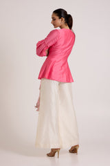 Jay pink Velan top and ivory pants, back view showing the fitted back and puff sleeves