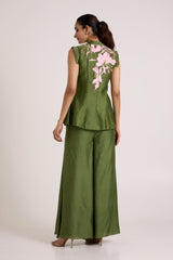 Olive Stacy set looking over the shoulder, back view with pink floral applique on the vest