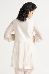 Ivory Abe 2.0 tunic back view showing the micro-gathered peplum and balloon sleeves