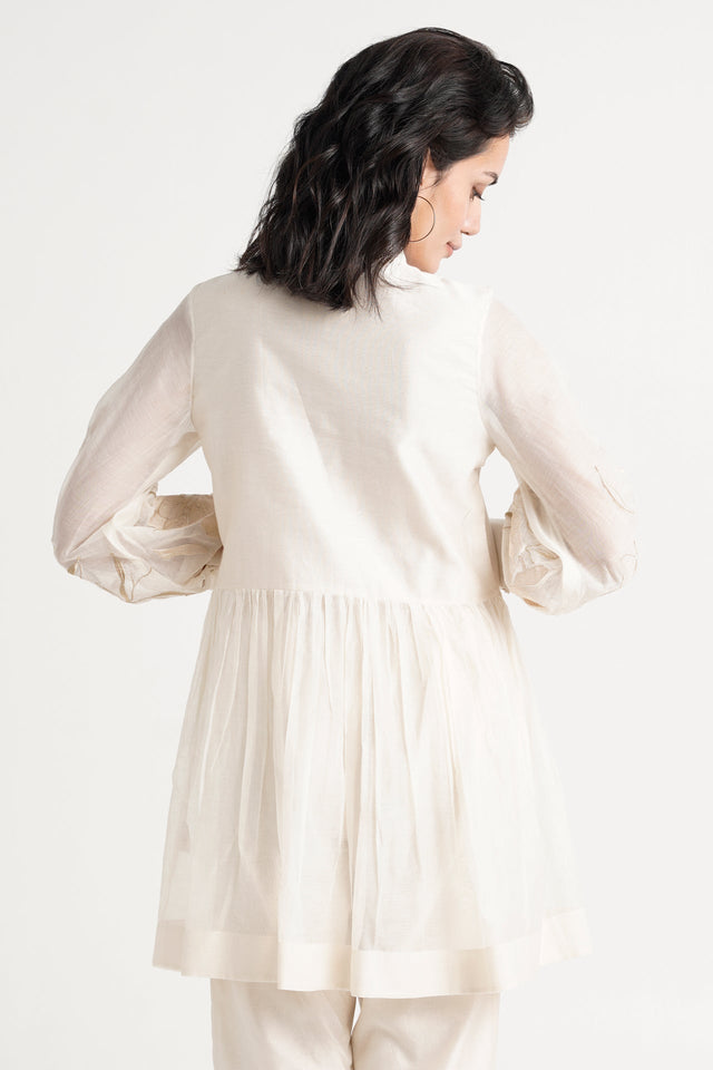Ivory Abe 2.0 tunic back view showing the micro-gathered peplum and balloon sleeves
