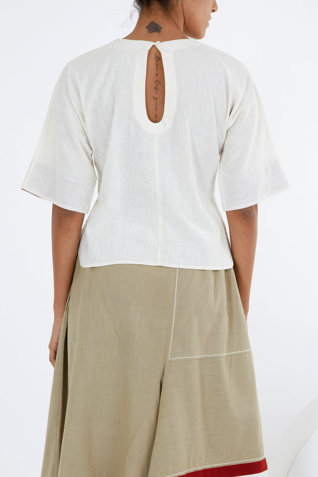 Ivory crop top back view showing the keyhole opening at the nape and dropped shoulders
