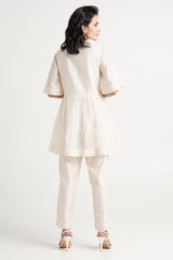 Ivory Abe 2.5 peplum tunic set, back view showing the gathered peplum and wide sleeves
