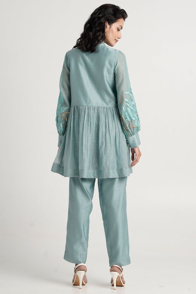 Aqua Abe 2.0 peplum tunic set back view showing the embroidered sleeves and gathers