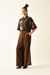 Earth Bloom box shirt set with pleated wide leg trousers and a hand on the hip, full length view