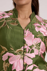 Close-up of the Stacy vest notched collar, gold buttons and pink floral applique