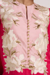 Close-up of the Cory dress notched neckline, gold button placket and floral applique
