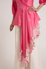 Close view of the Velan top cascading drape with floral applique over ivory pants