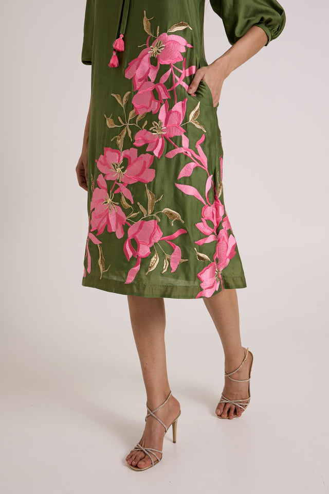 Close view of the Vinny dress side pocket and pink floral applique on the skirt