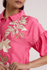 Close-up of the Avina midi dress floral applique and piped puff sleeve seam