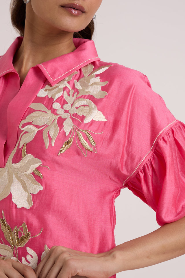 Close-up of the Avina midi dress floral applique and piped puff sleeve seam