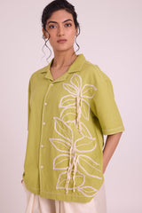 Close front view of the Binda shirt notch collar and textured white floral embroidery