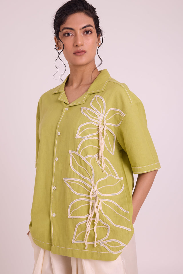Close front view of the Binda shirt notch collar and textured white floral embroidery