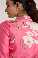 Close back view of the Eddie pink top shoulder with ivory floral applique and gold sequins
