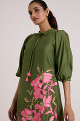 Close view of the Vinny olive dress puff sleeve, tassel tie and pink floral applique