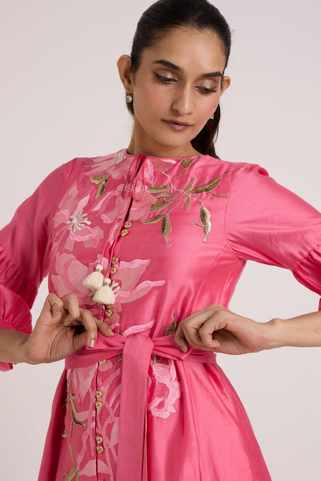 Close-up of the Delphi pink dress bodice with tassel tie, buttons and waist belt