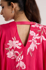 Close-up of the Zuma pink top V back opening with pale pink floral applique