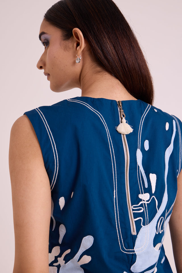 Close back view of the Hudson dress zip with shell pull and piped seams
