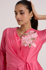 Close view of the Velan pink top V neckline with pale pink floral applique