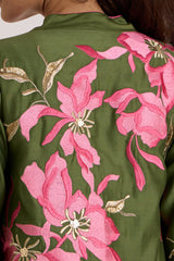 Close-up of the Rafiya olive jacket back with large pink floral applique and gold leaves