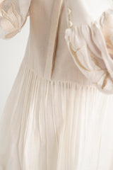Close-up of the Ivory Abe 2.0 micro-gathered peplum seam and sleeve embroidery