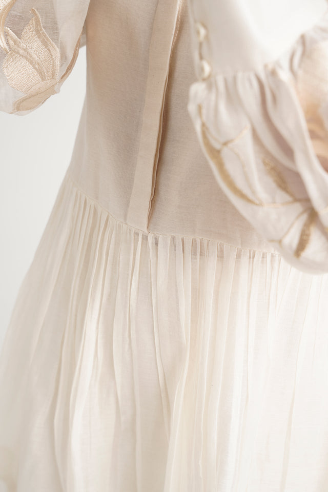 Close-up of the Ivory Abe 2.0 micro-gathered peplum seam and sleeve embroidery