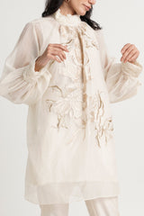Close view of the Alba ivory tunic floral embroidery and gathered balloon sleeves