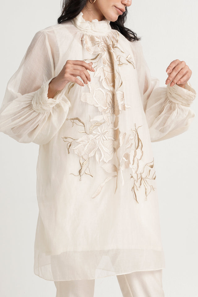 Close view of the Alba ivory tunic floral embroidery and gathered balloon sleeves