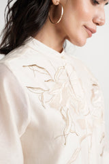 Close-up of the Ivory Abe 2.5 band collar and tonal floral embroidery on the bodice