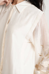 Close view of the Buckler ivory kurta layered shoulder panel and embroidered sleeve