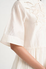 Close-up of the Ivory Abe 2.5 wide sleeve cuff and embroidery at the shoulder