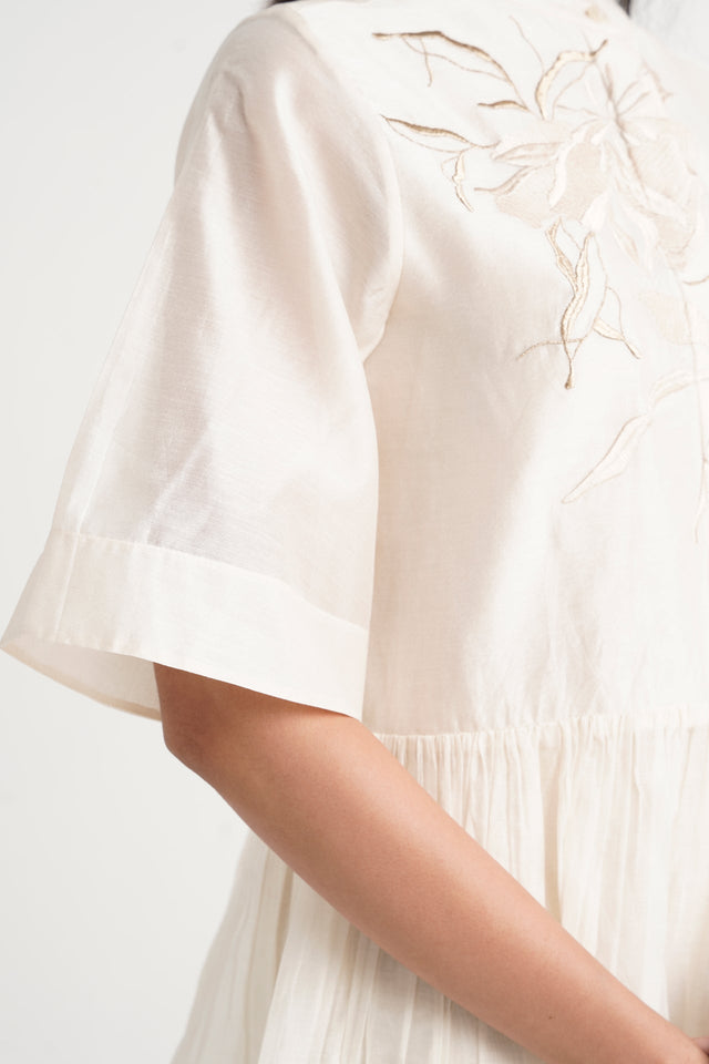 Close-up of the Ivory Abe 2.5 wide sleeve cuff and embroidery at the shoulder