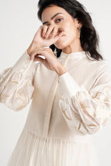 Ivory Abe 2.0 tunic with a hand raised, close front view of the embroidered balloon sleeves