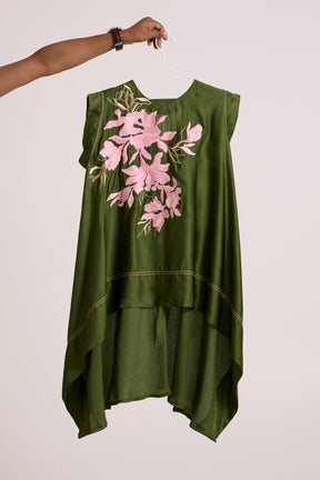 Olive Ice Zuma Fly High Trail Top by Madder Much, olive asymmetric sleeveless top with pink floral applique on a hanger
