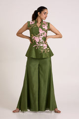 Olive Stacy peplum vest and flare pants with hands on the waist, full length front view