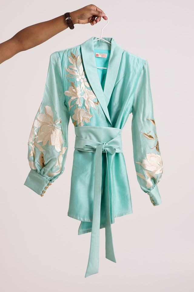 Aqua Alfie Obi Belt Blazer Top by Madder Much, shawl collar blazer top with ivory floral applique sleeves on a hanger
