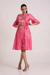 Jay pink Delphi midi dress with tie waist and flared sleeves, front view with a hand on the hip