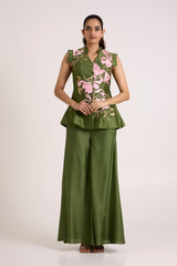Olive Stacy set with arms relaxed, straight front view of the embroidered peplum vest