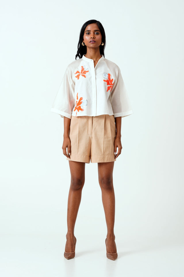 Ivory Zola crop shirt and pleated beige shorts with heels, straight front view